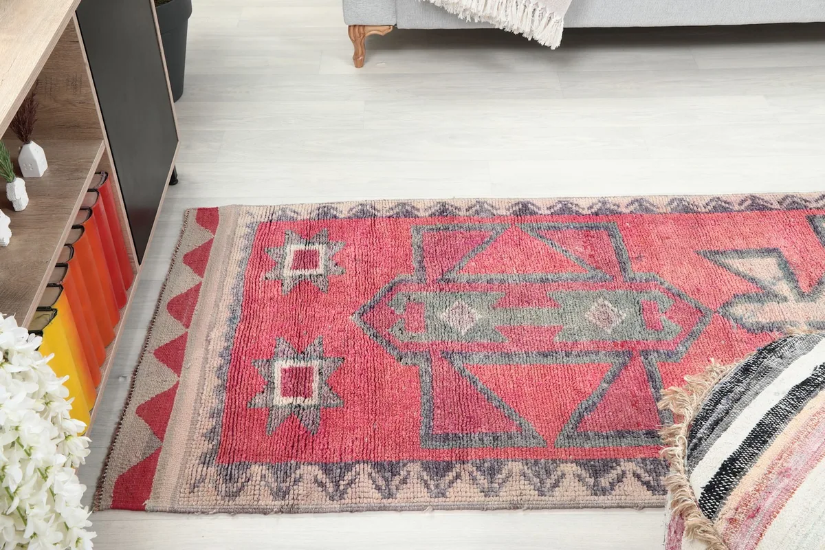 View of the runner rug extending under a sofa in a home decor setting
