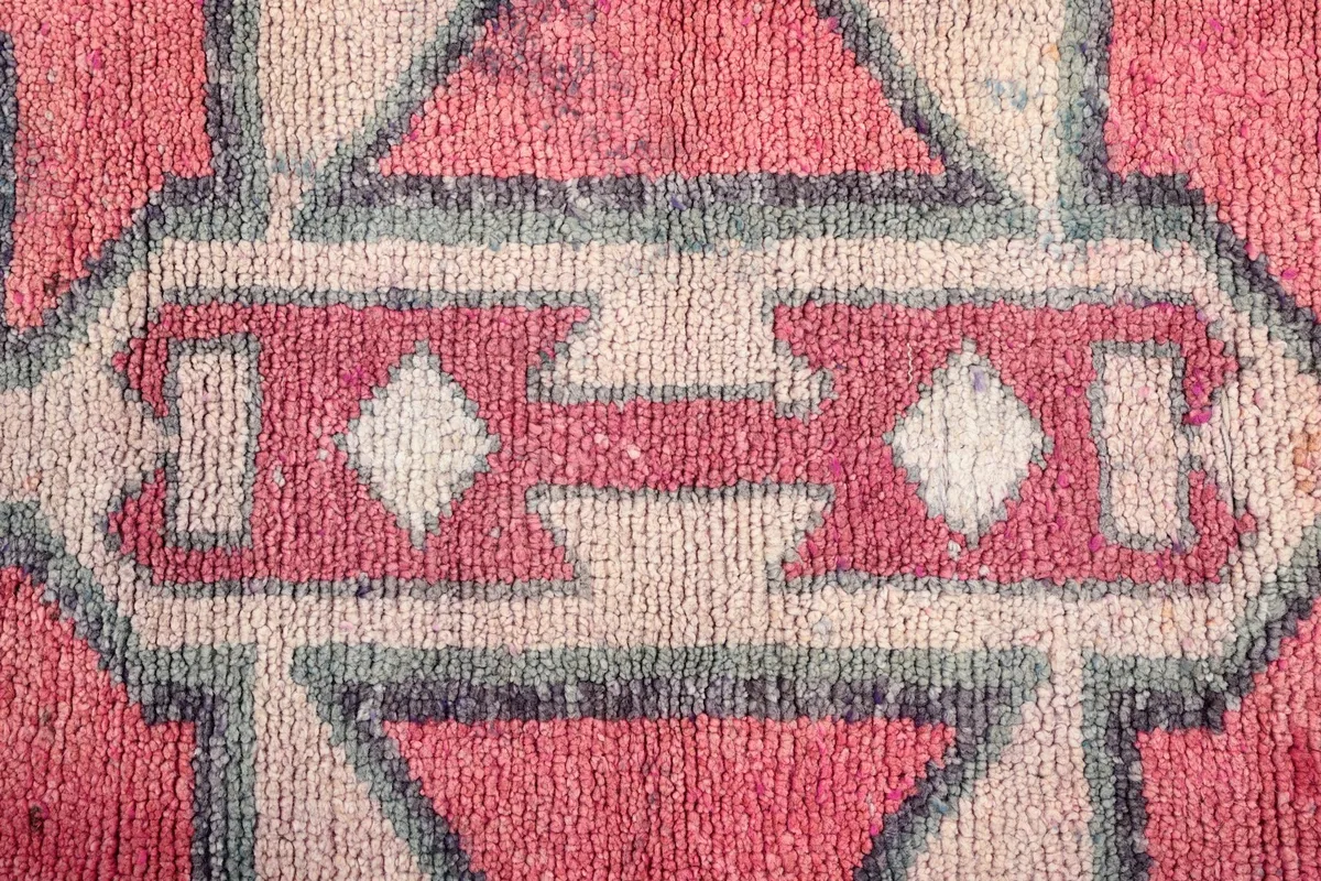 Close-up detail of the hand-knotted wool pile and intricate central geometric design