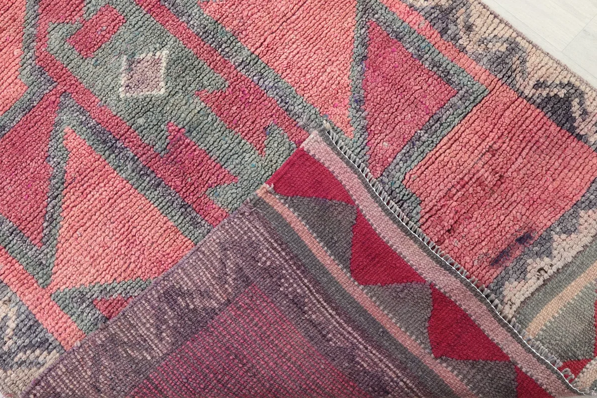 View of the back of the rug revealing the foundation and knotting structure