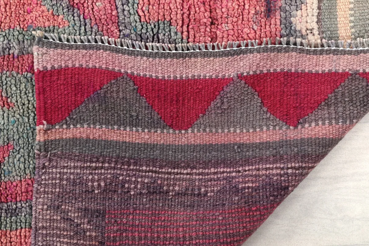Close-up of the rug's reverse side, showing the hand-knotted cotton foundation