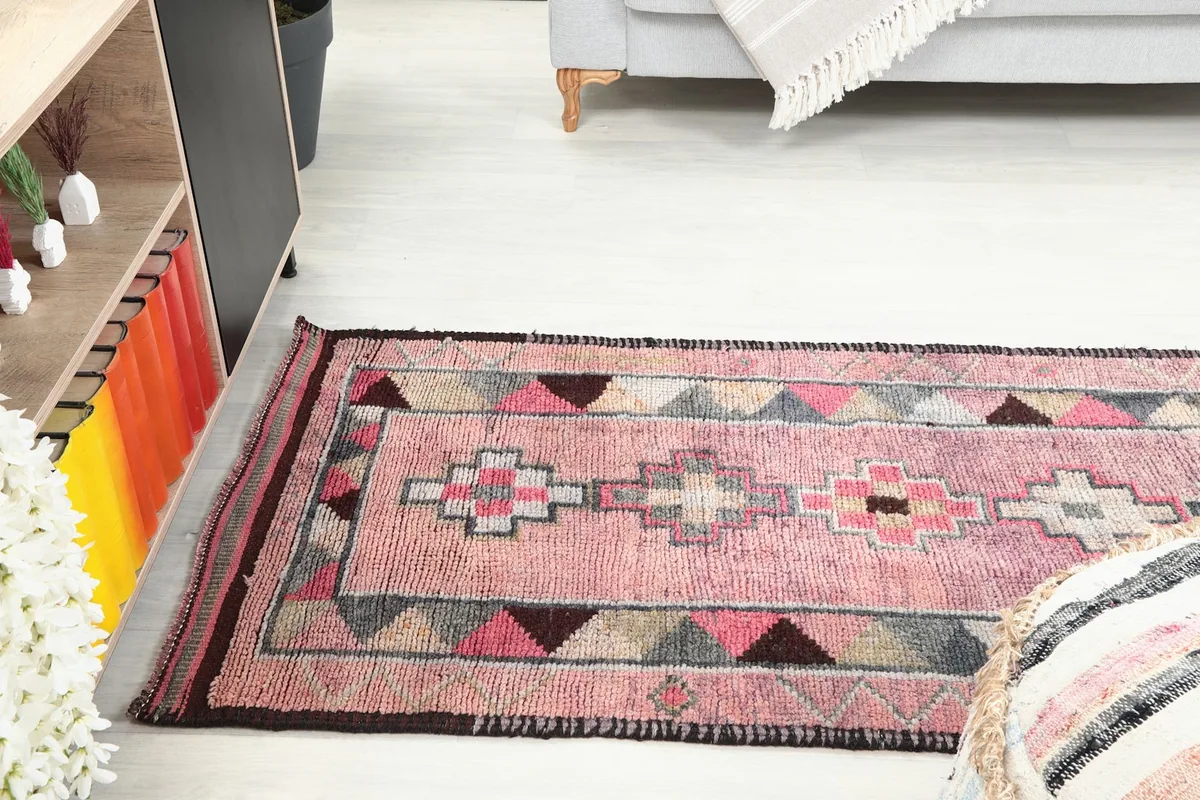 Side view of the vintage runner rug in a room, showing its length and how it complements the decor