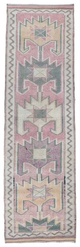 Full overhead view of the vintage Anatolian runner with rose, gray, and beige geometric patterns