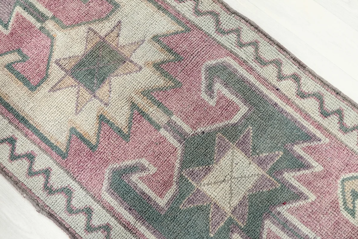 Close-up showing the varied geometric shapes and subtle color transitions in the rug's design