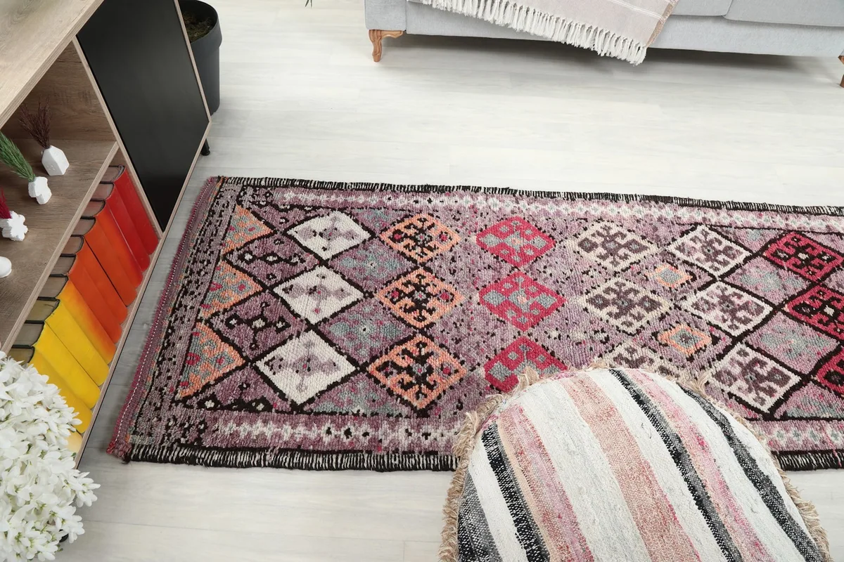 Angled view looking down the length of the runner, showing the progression of the geometric motifs and color variations.