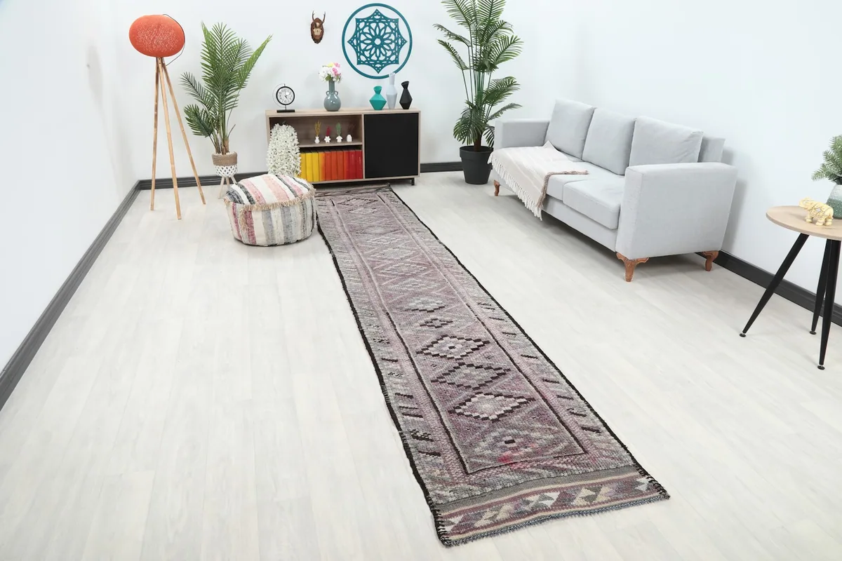 Angle view of the rose geometric runner rug extending through a hallway in a contemporary home setting.