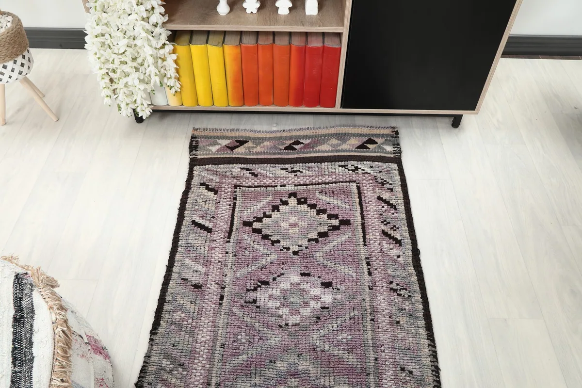 Overhead view of a section of the runner rug in a room, emphasizing its linear pattern and placement.