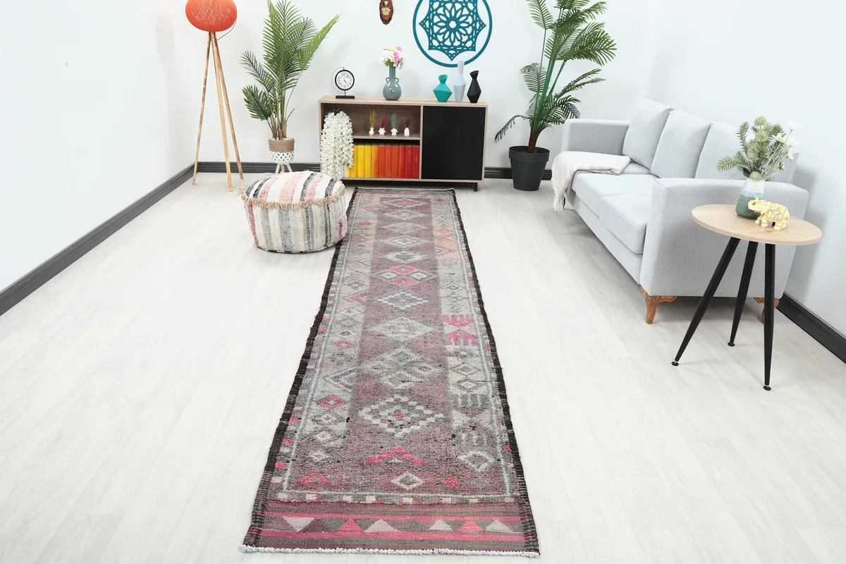 Runner rug displayed in a modern living space, showing its length and colors in context.