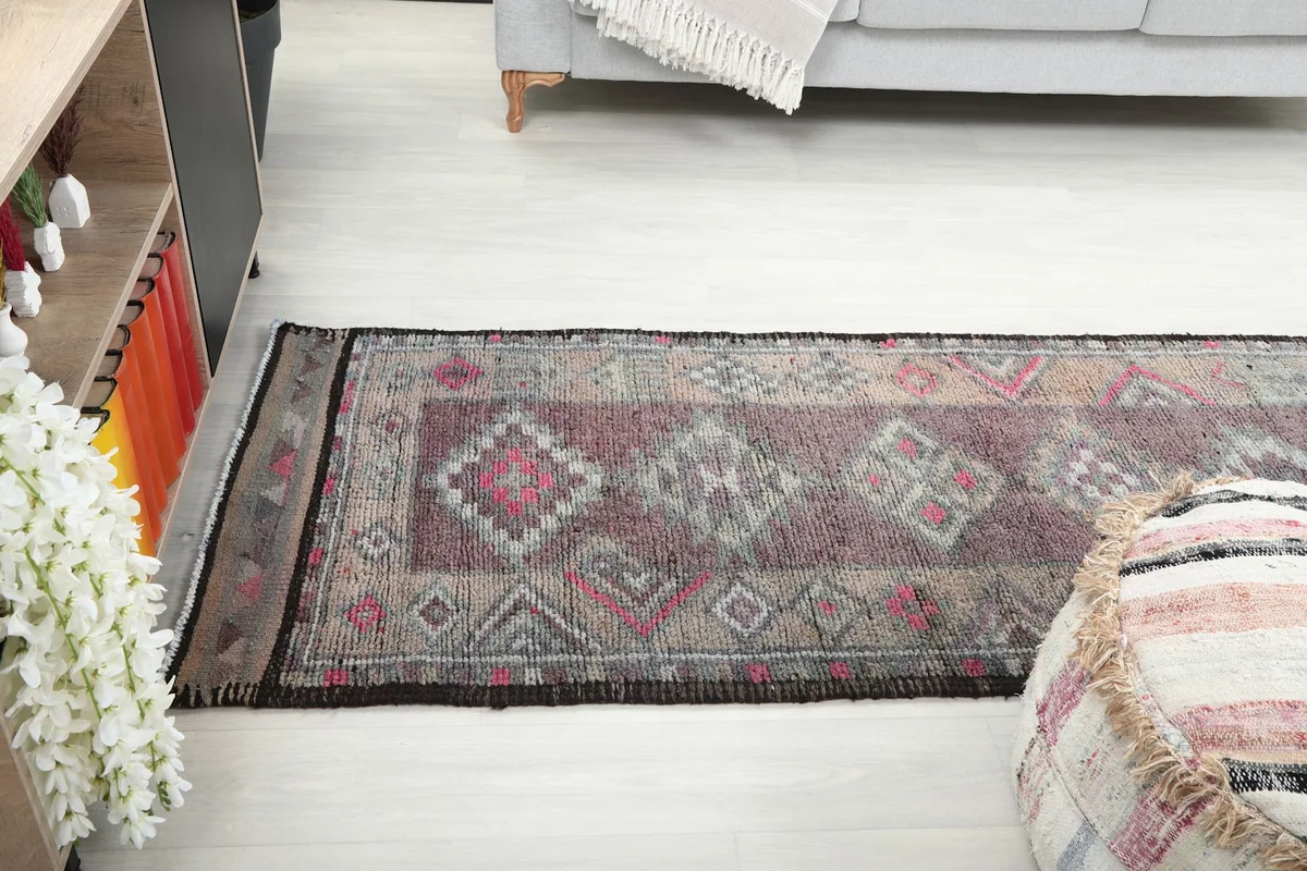 View of the runner rug extending across a room, from a slightly elevated perspective.