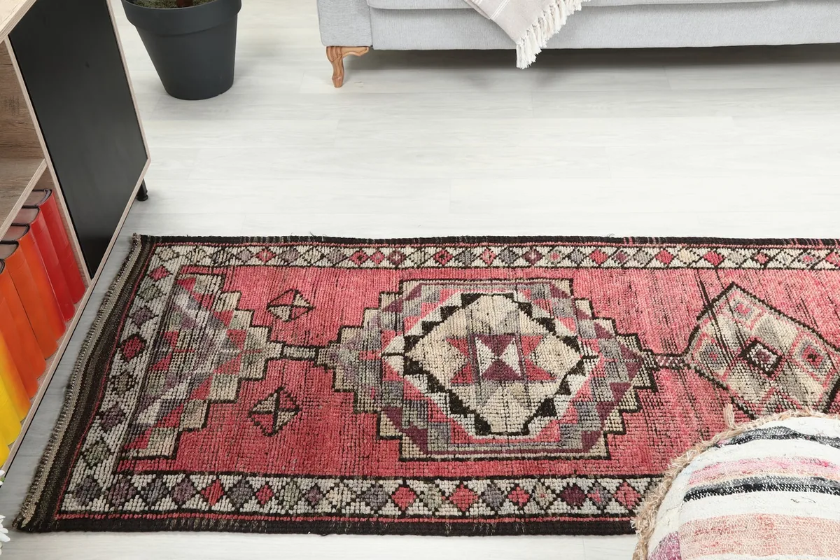 Long view of the runner rug extending down a hallway, showing its scale