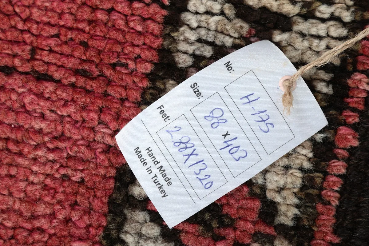 Label showing the rug's dimensions and origin: hand made in Turkey
