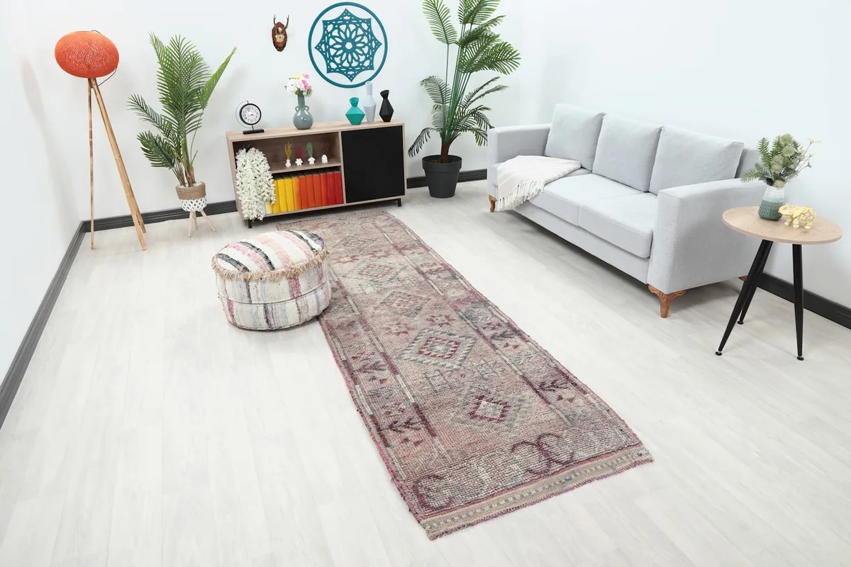 Angled view of the rose and gray runner rug in a contemporary room setting