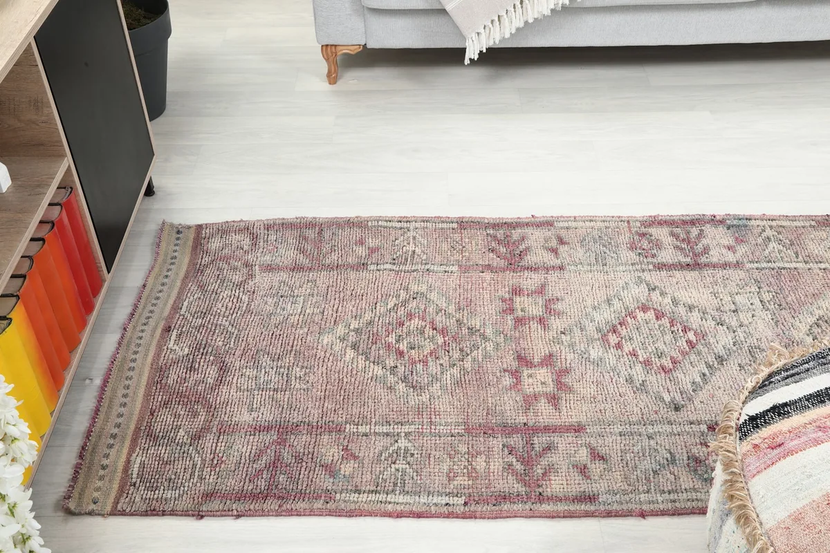 View down the length of the runner rug in a room, showing its elongated shape