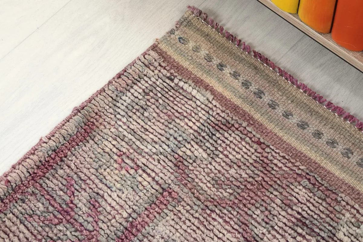 Detail of the rug's border pattern, featuring small repeating geometric shapes
