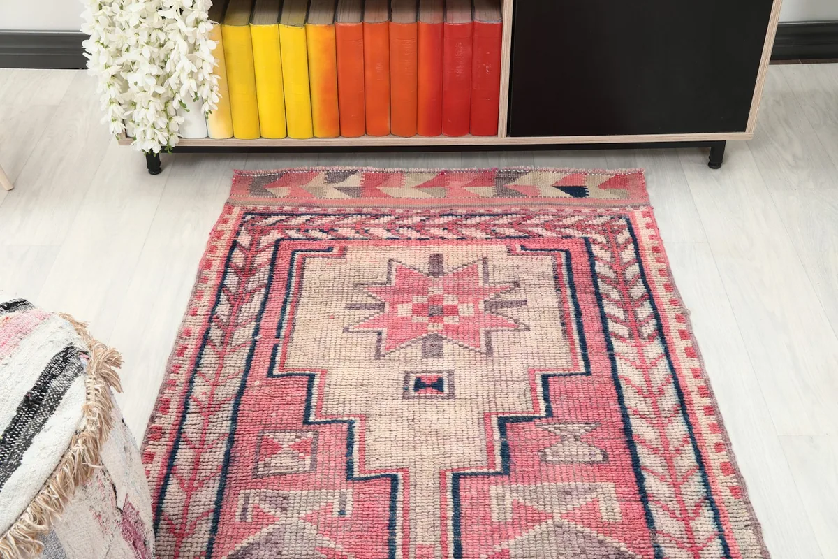 Top-down angle of the rug's end, featuring a prominent star-like geometric motif