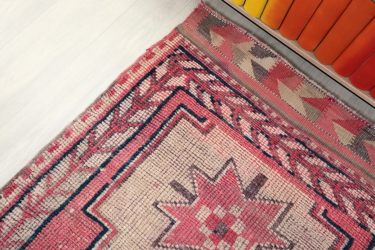 Corner detail of the runner rug, showing the intricate border design and color blending