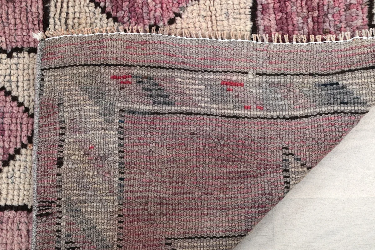 Close-up of the back of the rug, revealing the hand-knotted construction