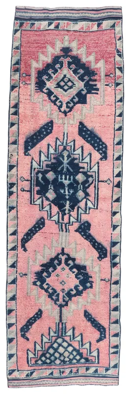 Full top view of the 3'3" x 11'0" pink and navy geometric Anatolian runner rug on a white background