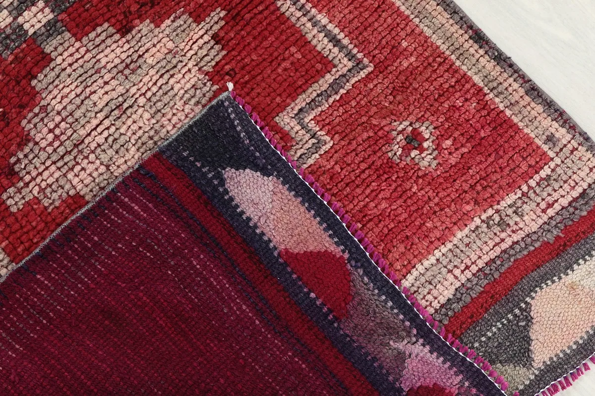 Underside of the hand-knotted wool rug, revealing the cotton foundation and construction