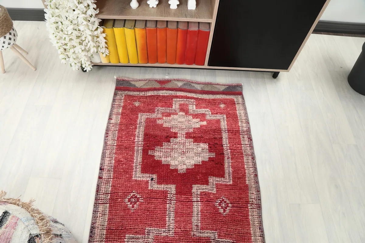 Overhead shot of the rug's upper section, displaying the repeating geometric patterns