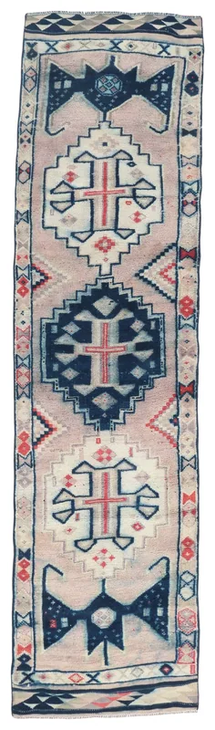 Full top view of the vintage Anatolian runner with beige field and navy tribal motifs