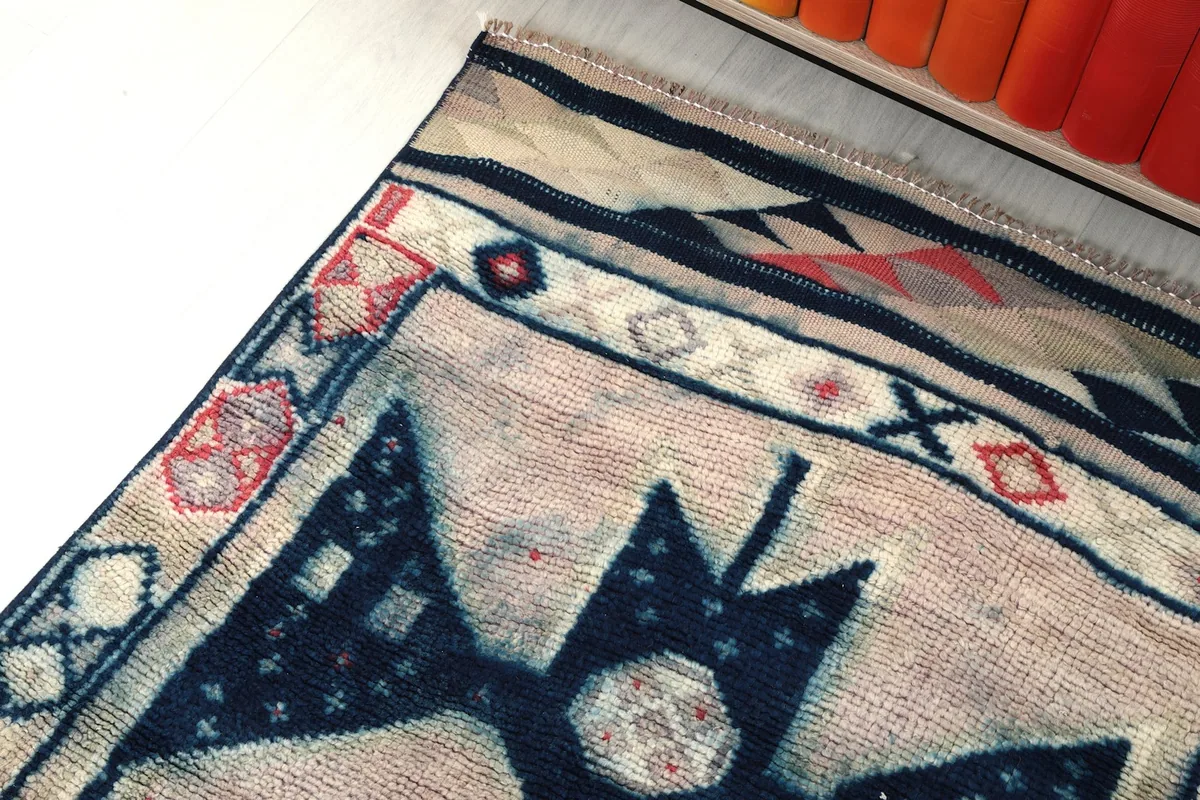 Angled view showing the rug's surface texture and color variation near the border