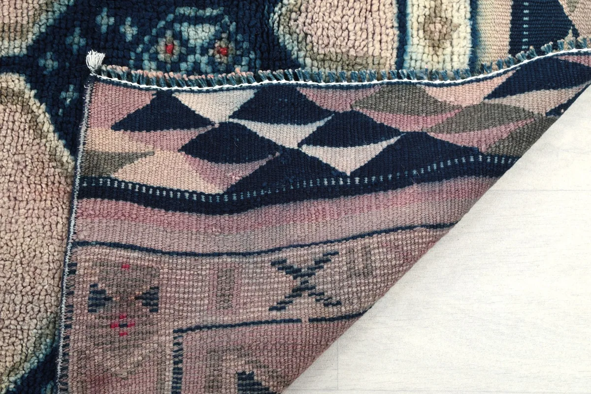 Close-up of the back of the rug, showing the knotting and foundation structure