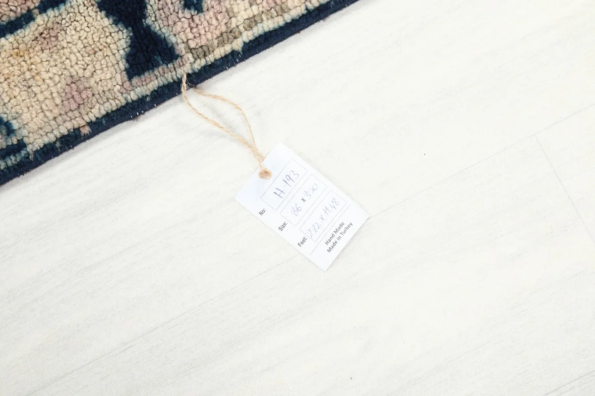 Photo of the rug's product tag on a white floor