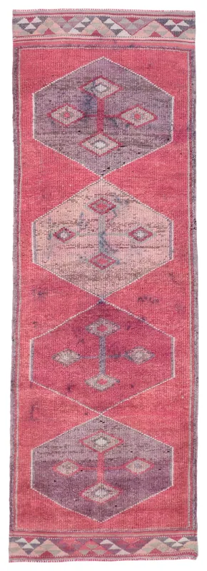 Full top view of the 3'4" x 10'3" faded red geometric Anatolian runner rug on a white background.