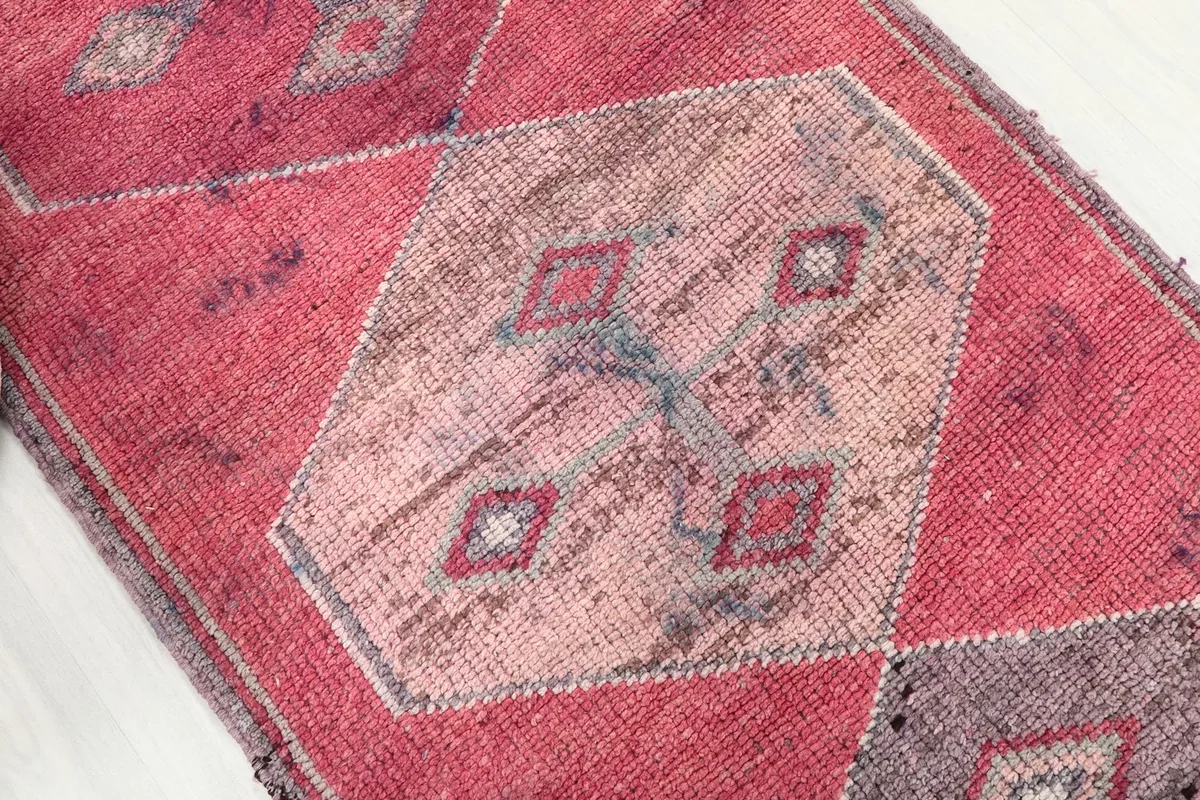 Close-up of a lighter geometric medallion, showing the subtle color variations and wear.