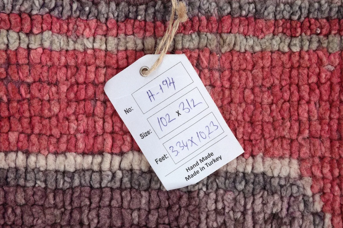 Tag showing the rug's dimensions as 102 x 312 cm and 3'3" x 10'2" (actual is 3'4" x 10'3"), hand made in Turkey.