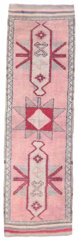 Full overhead view of the rose geometric Anatolian runner rug on a white background
