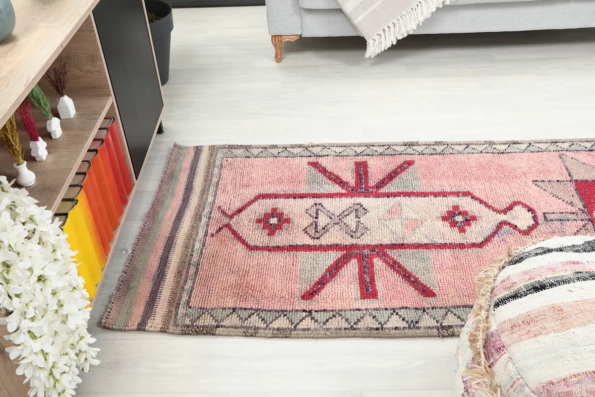 View of the runner rug stretching from a seating area towards a bookshelf