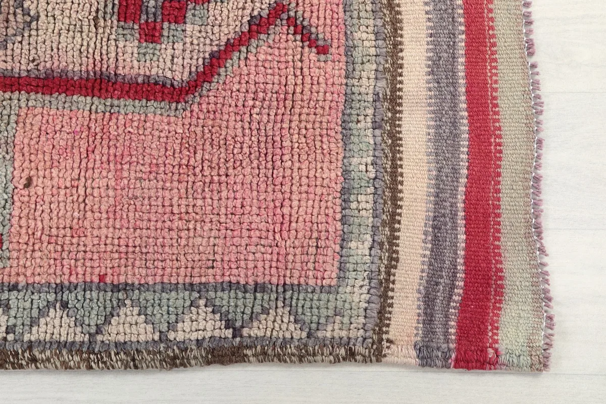 Close-up detail of the rose field and geometric patterns on the rug's surface
