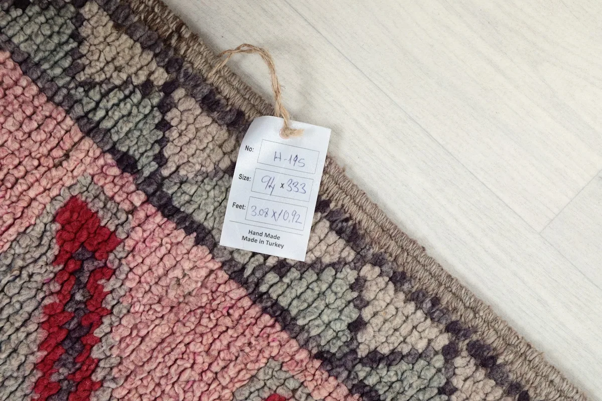 Detail of the rug tag showing dimensions and origin on the wool pile surface