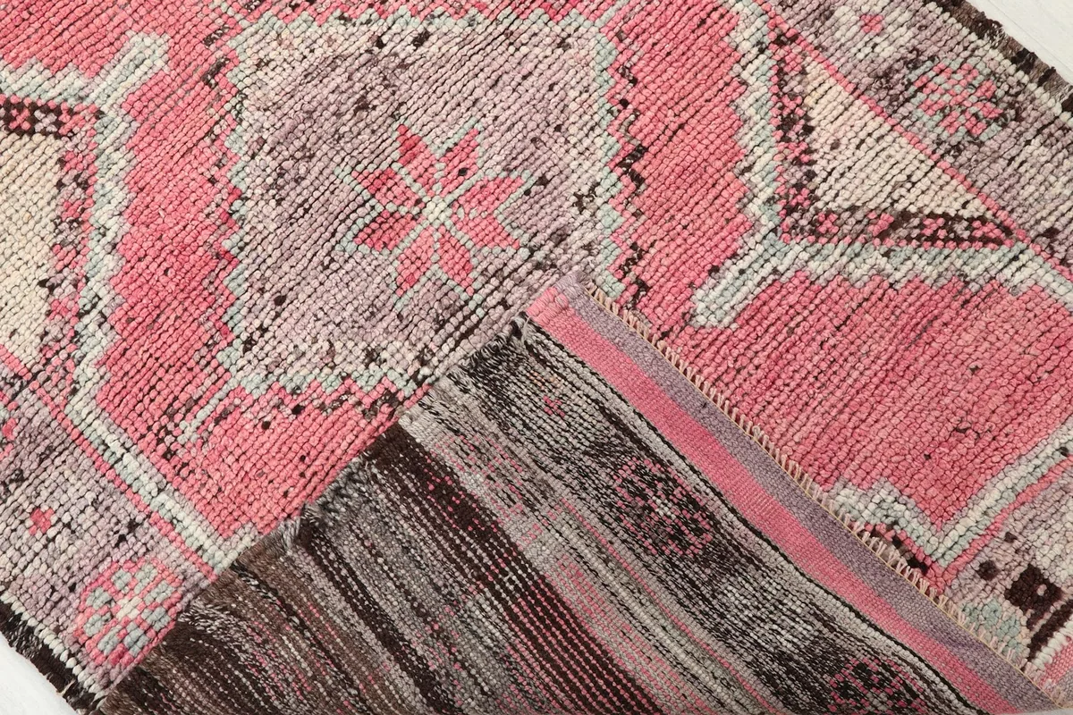 Underside of the hand-knotted wool rug, showing the cotton foundation and construction