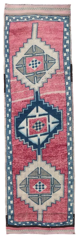 Full overhead view of the vintage Anatolian runner rug with rose field and geometric motifs.