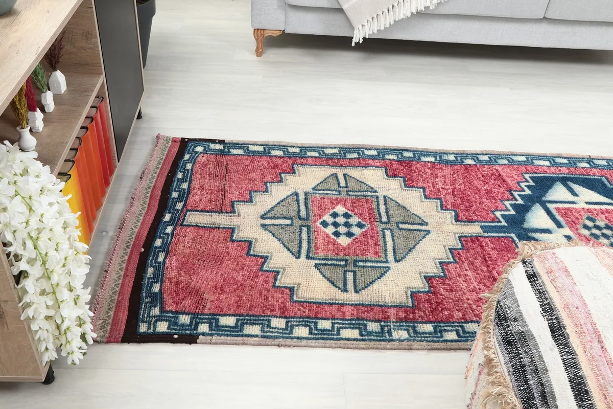 Angled view of the rug from the side, extending into the room.
