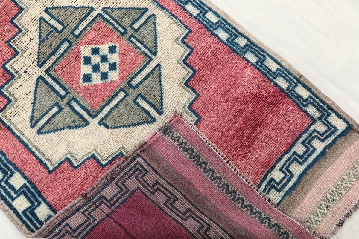 View of the rug's reverse side, showing the cotton foundation and knotting.