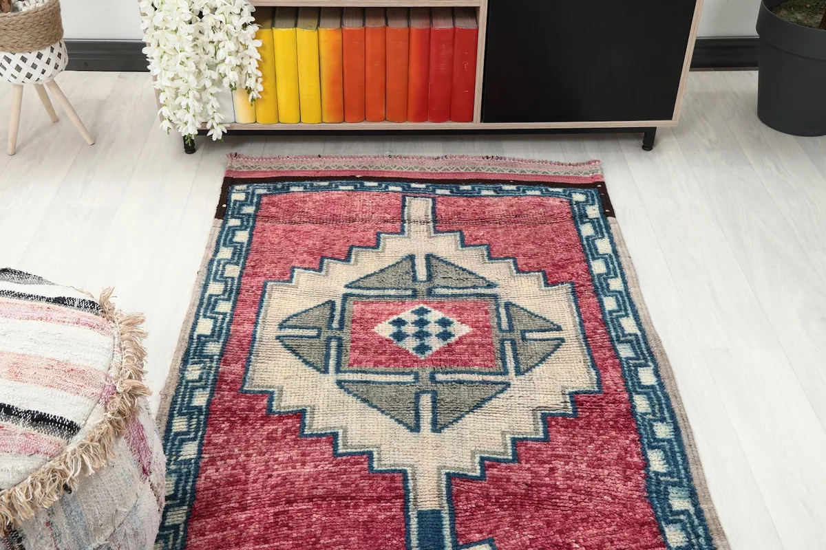 Overhead view focusing on one end of the runner rug and its tribal design.