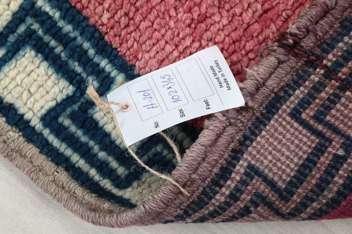 Tag showing the rug's dimensions and origin, attached to the back of the rug.