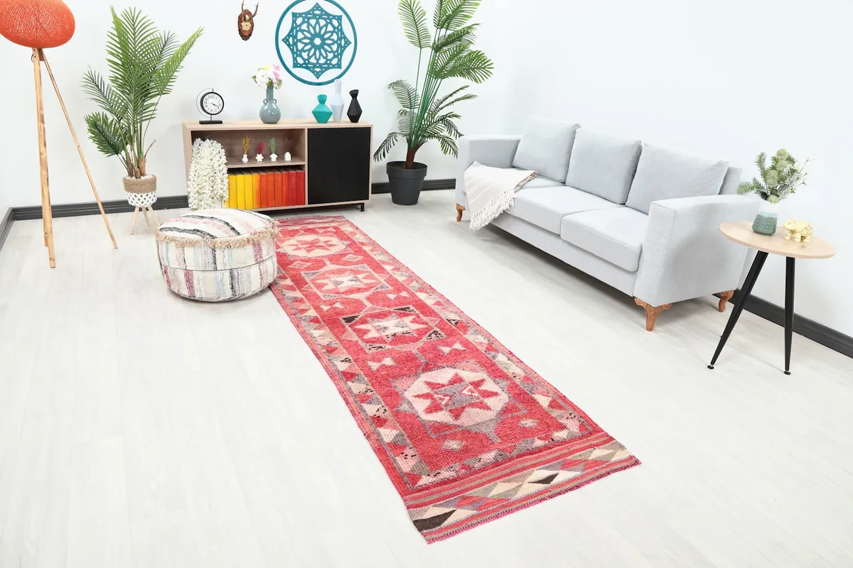 Red vintage runner rug extending through a contemporary living space