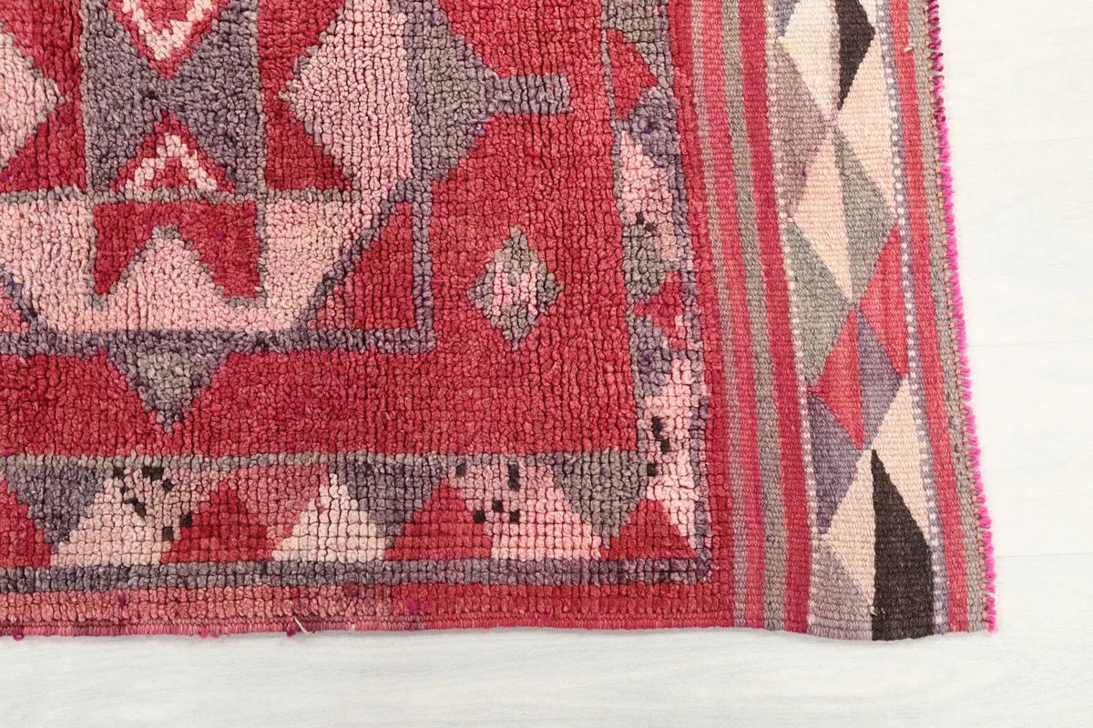 Close-up of the rug's border and main field, highlighting colors and patterns