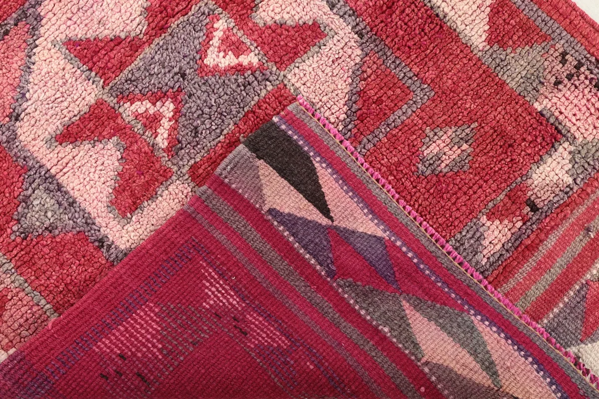 View of the back of the rug, revealing the hand-knotted construction and foundation