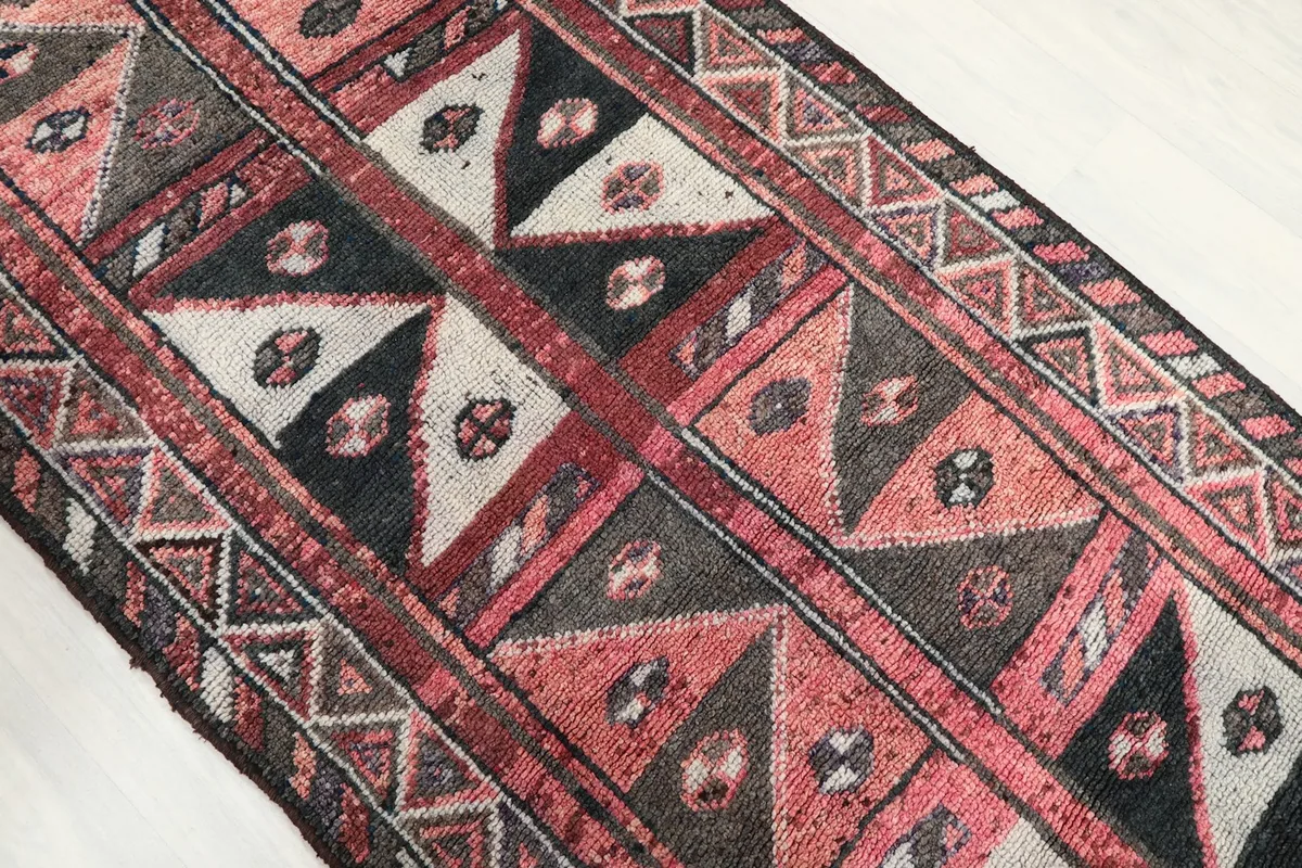 Overhead angle capturing the intricate geometric and tribal patterns across the vintage runner's surface.