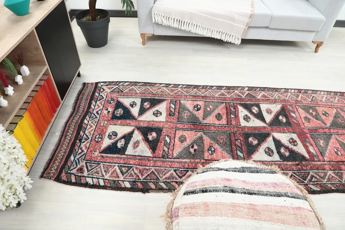 Perspective view of the long runner rug extending through a living area, highlighting its length.