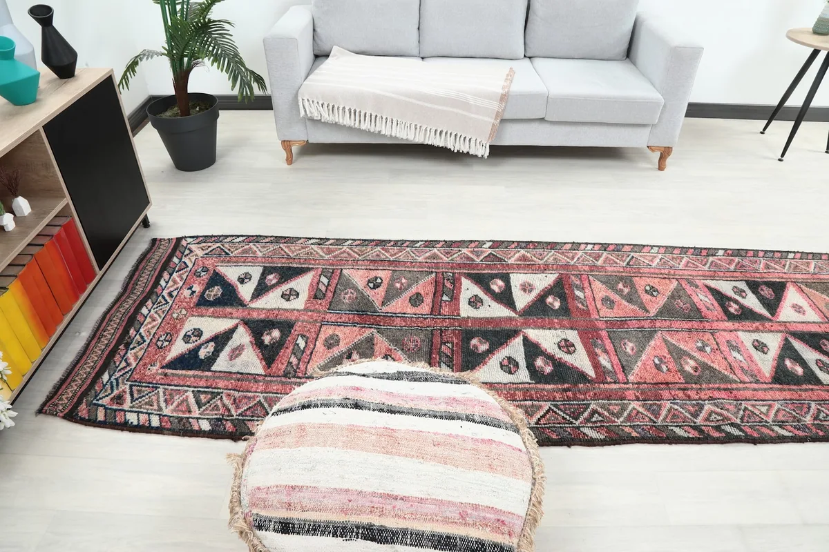 Full view of the runner rug in a room, showing its scale relative to a sofa and other decor elements.