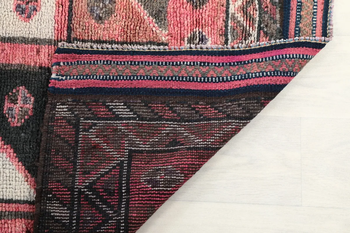 View of the back of the hand-knotted rug, showing the cotton foundation and knotting detail.