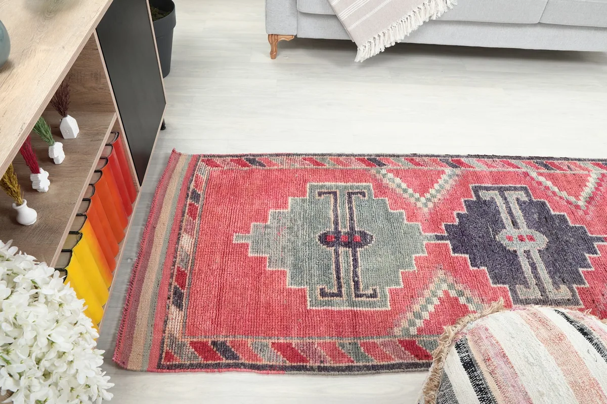 View of the rose runner rug extending through a living area, demonstrating its use as a hallway or entryway piece