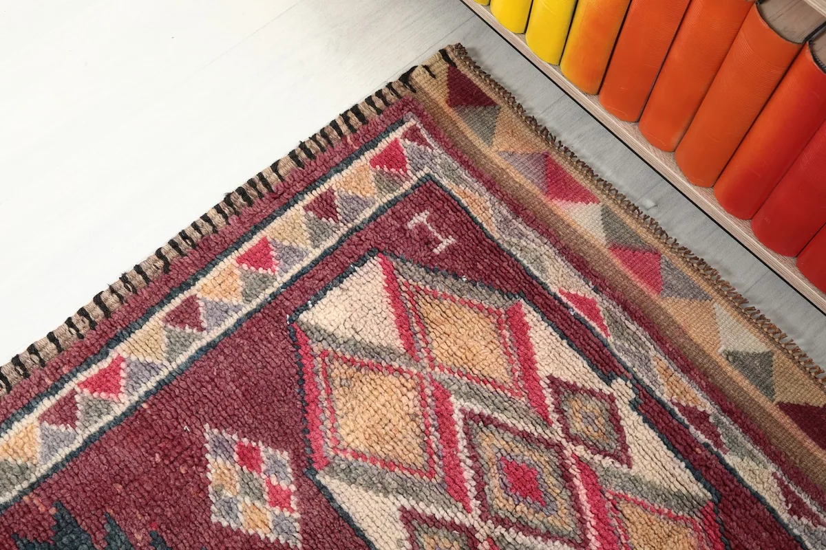Close-up of the rug's border and a corner with visible motifs
