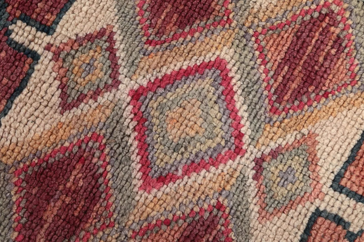 Macro view of the hand-knotted wool pile and texture of the rug
